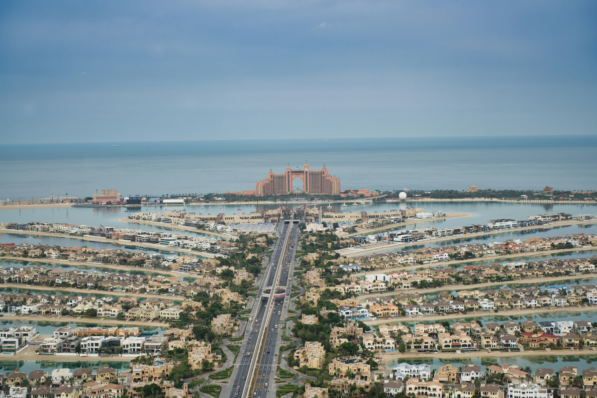 An aerial view of Palm Jumeirah villas The Atlantis on the crescent on a relatively cloudy day.